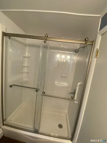 a bathroom with a glass shower door