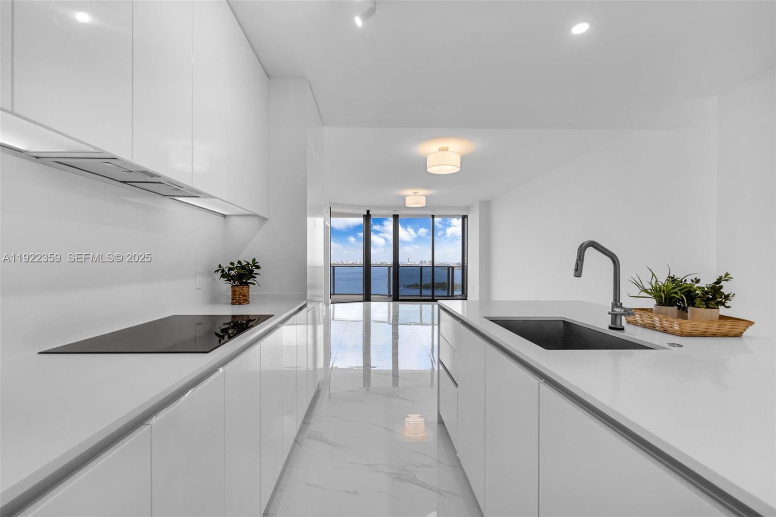 700 Northeast 24th Street, Unit 2003 Miami, FL 33137 - Photo 11 of 87 a kitchen with granite countertop a sink and cabinets