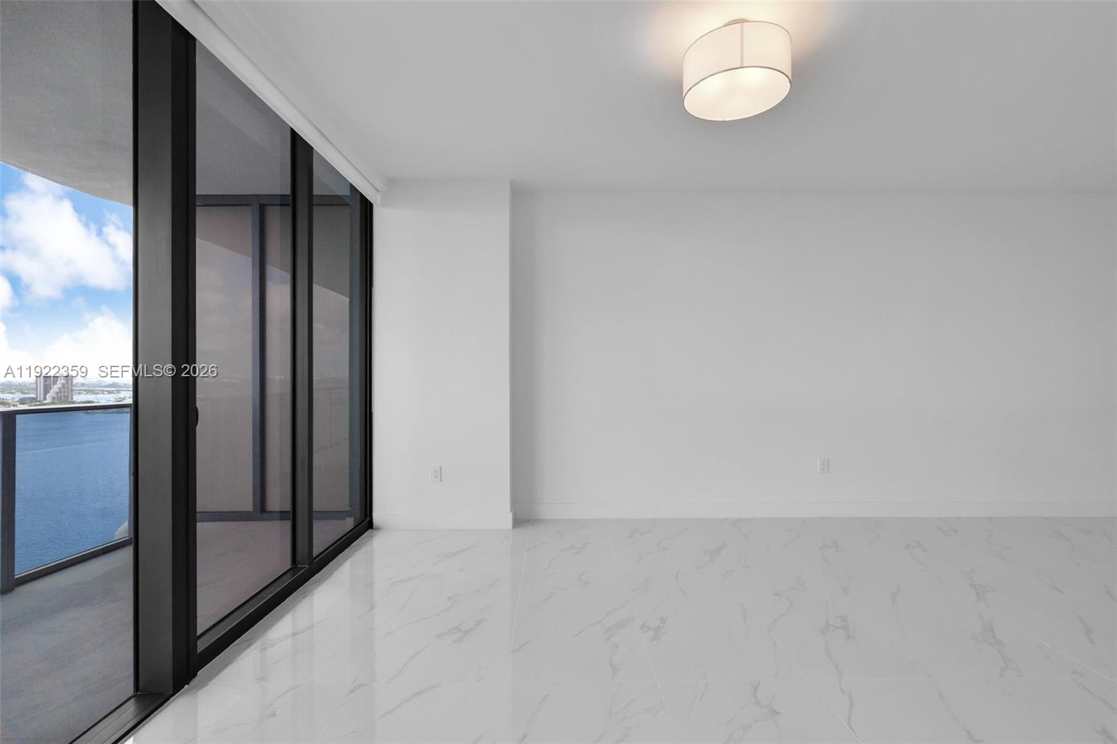 700 Northeast 24th Street, Unit 2003 Miami, FL 33137 - Photo 21 of 87 an empty room with wooden floor and windows