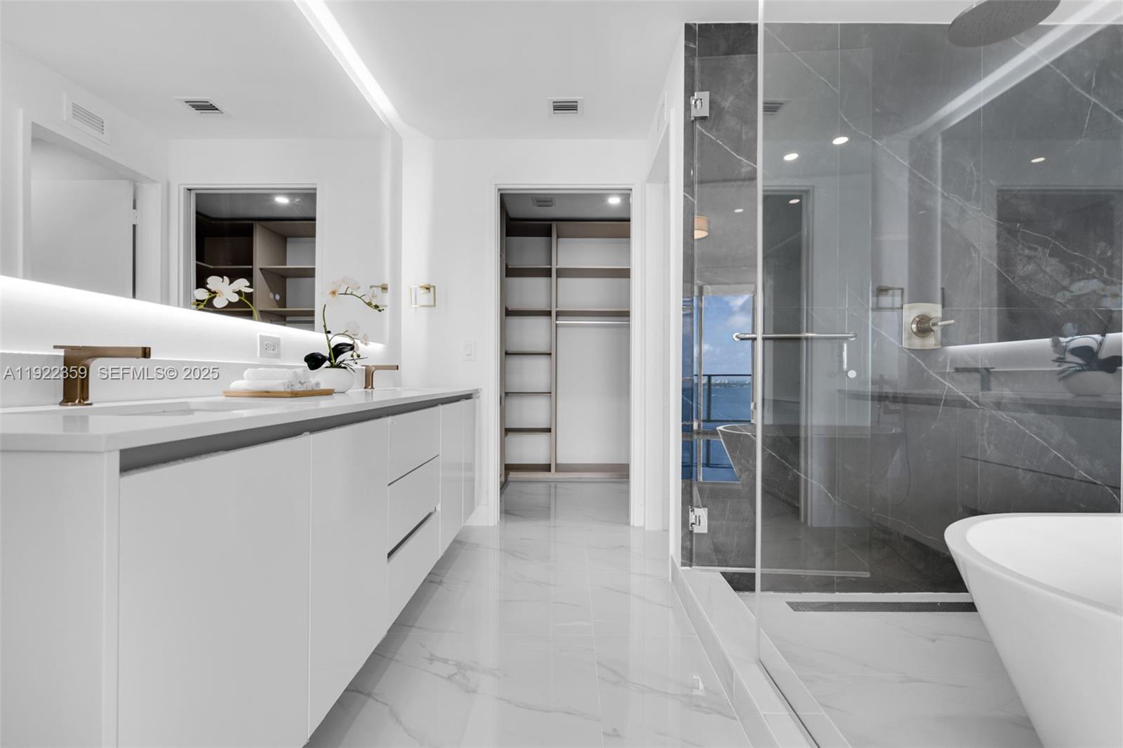 700 Northeast 24th Street, Unit 2003 Miami, FL 33137 - Photo 26 of 87 a bathroom with a double vanity sink a toilet and shower