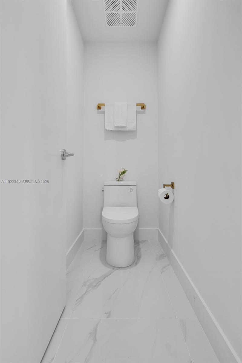 700 Northeast 24th Street, Unit 2003 Miami, FL 33137 - Photo 31 of 87 a bathroom with a toilet