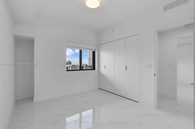 a living room with furniture and a glass door