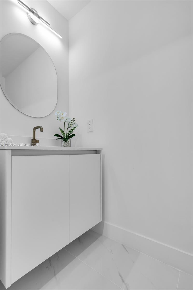 700 Northeast 24th Street, Unit 2003 Miami, FL 33137 - Photo 42 of 87 a bathroom with a sink and a mirror