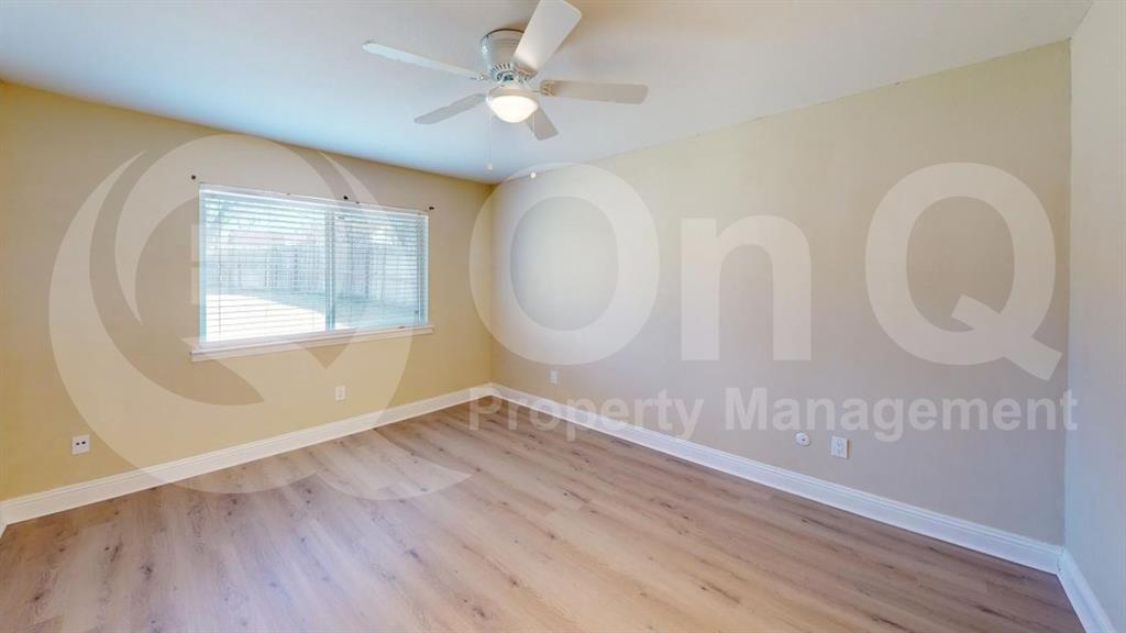 3005 Meandering Way Bedford, TX 76021 - Photo 16 of 24 Spacious room featuring wood-finish flooring, light-toned walls, and white baseboards