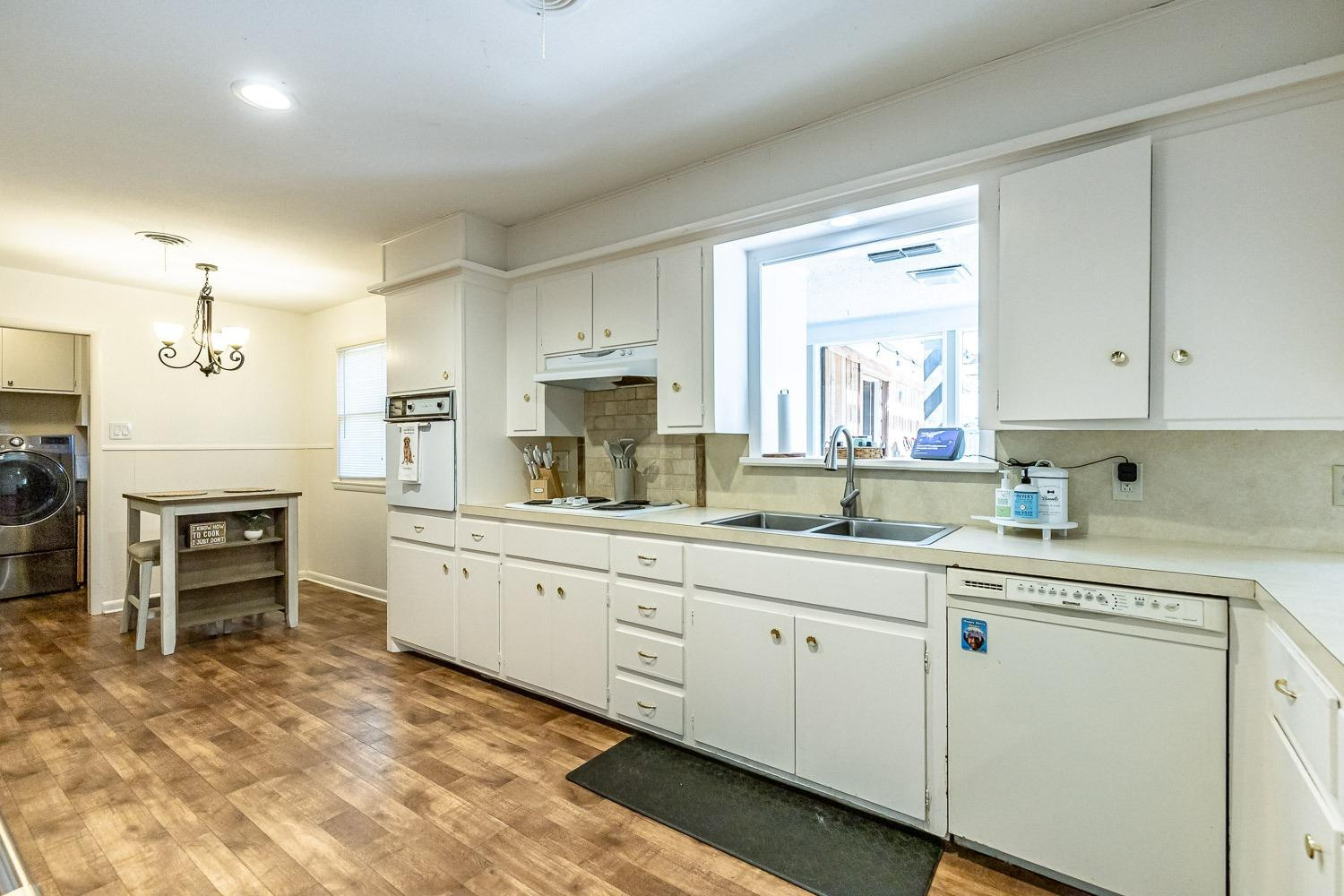 3604 48th Street Lubbock, TX 79413 - Photo 13 of 50 a kitchen that has a lot of cabinets in it and appliances