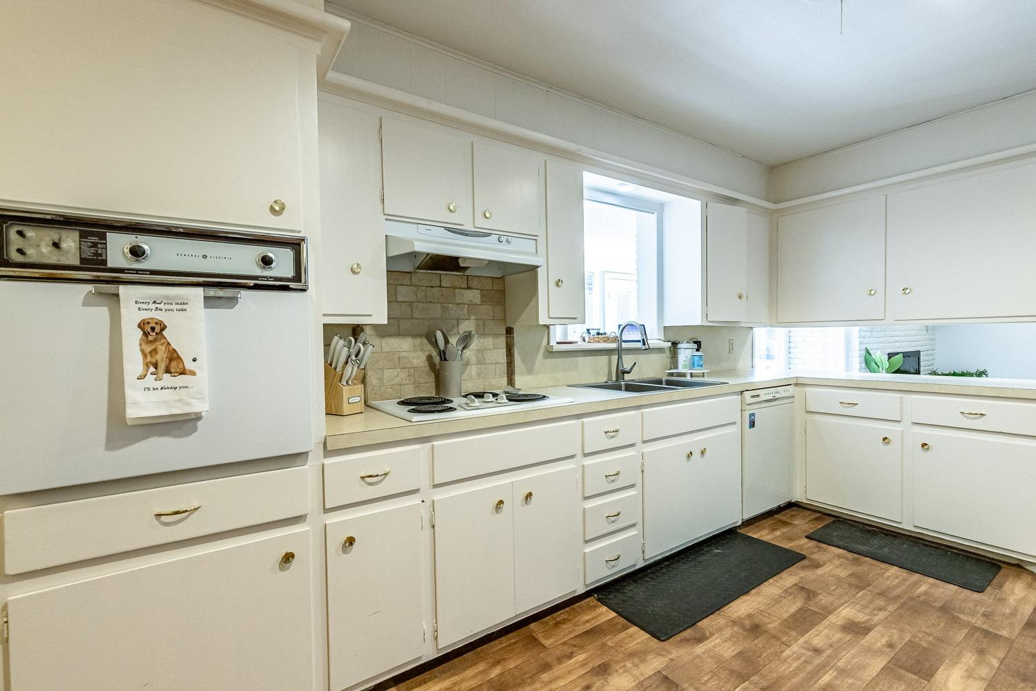 3604 48th Street Lubbock, TX 79413 - Photo 15 of 50 a kitchen with sink cabinets and window