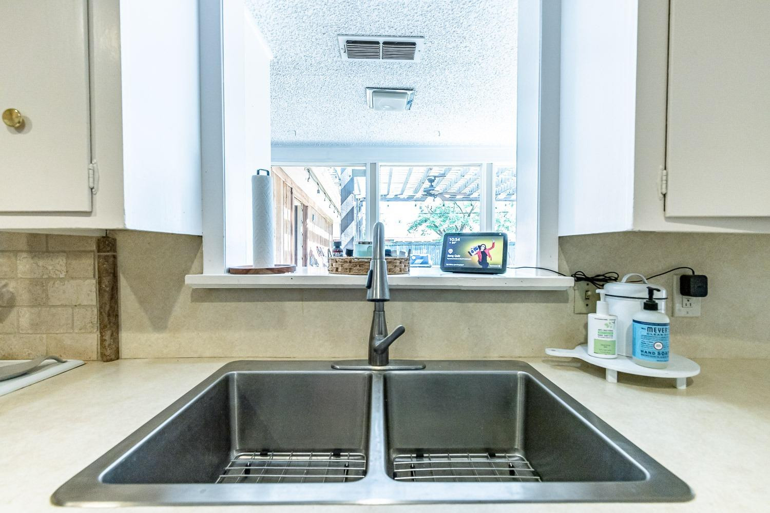 3604 48th Street Lubbock, TX 79413 - Photo 16 of 50 a kitchen with a sink and a window