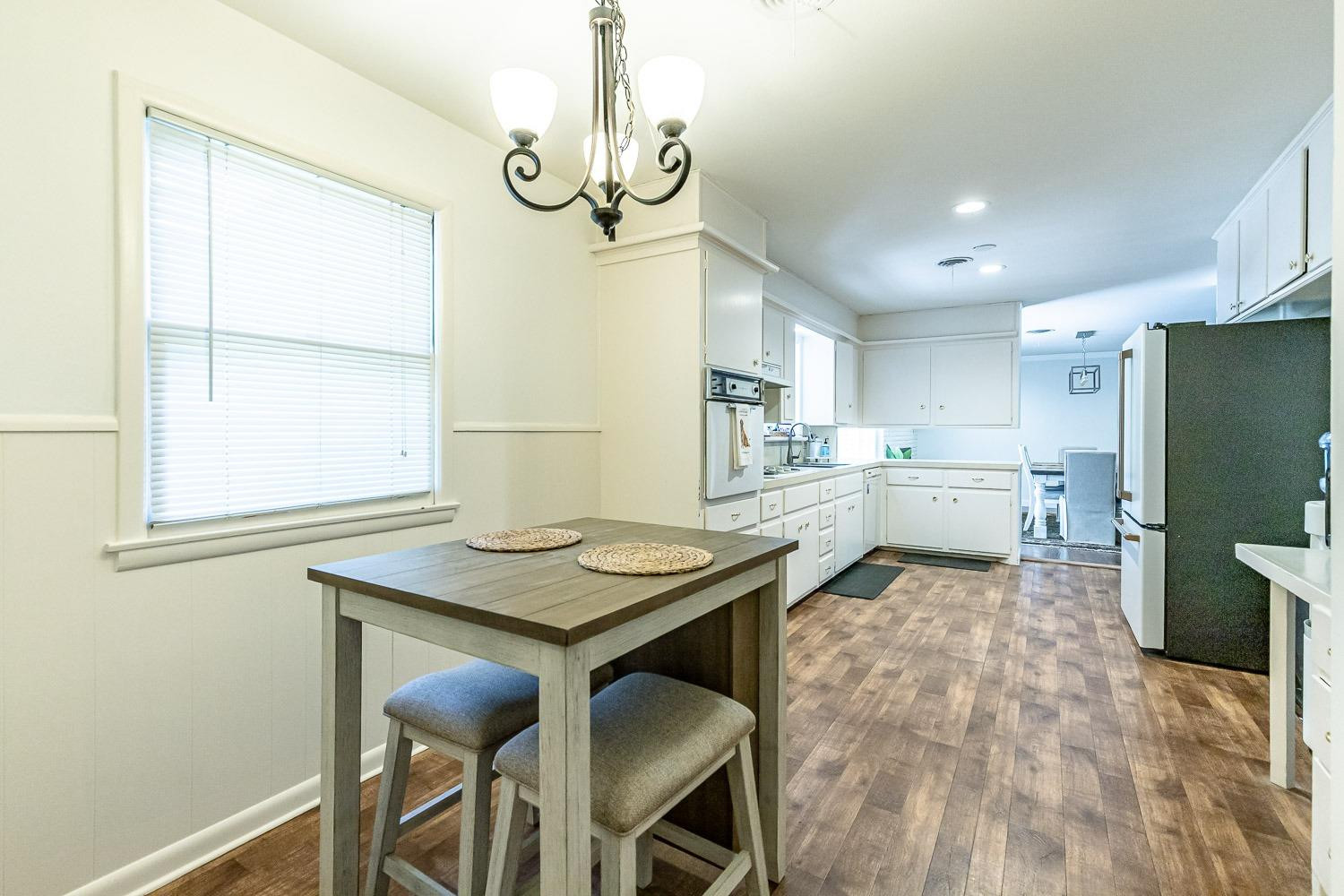 3604 48th Street Lubbock, TX 79413 - Photo 19 of 50 a kitchen with sink cabinets and dining table