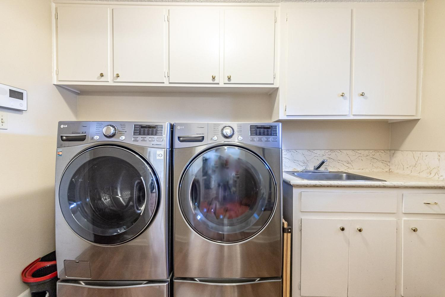 3604 48th Street Lubbock, TX 79413 - Photo 20 of 50 a close view of a utility room with dryer and washer