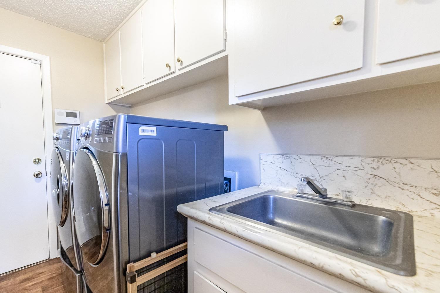 3604 48th Street Lubbock, TX 79413 - Photo 21 of 50 a utility room with dryer and washer