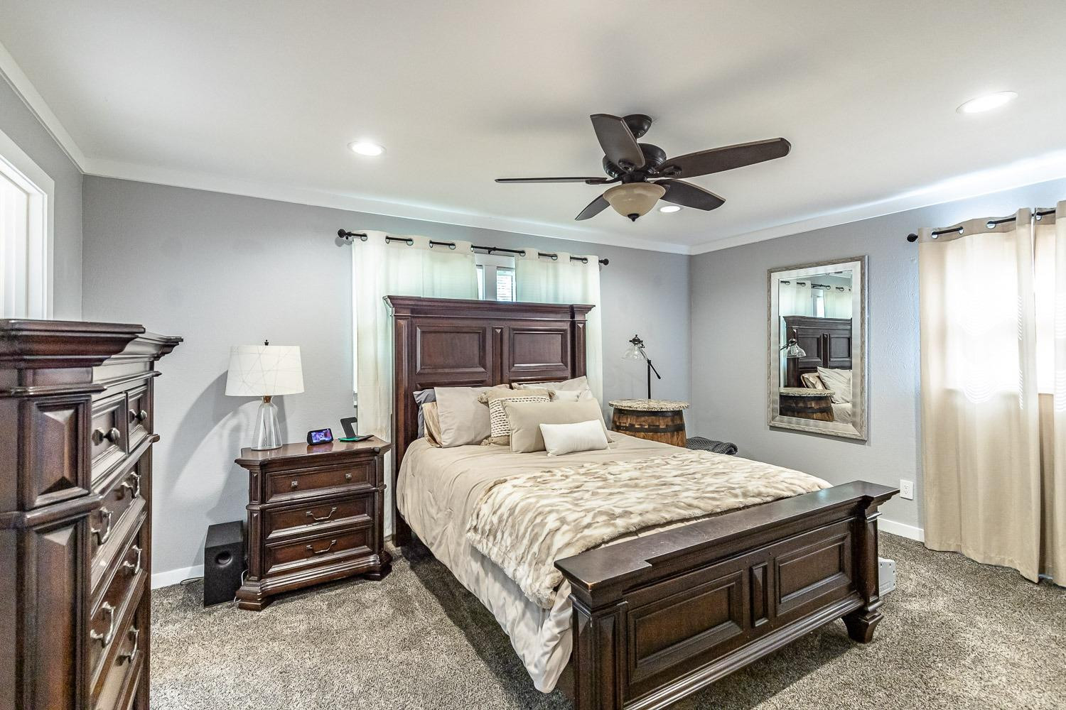 3604 48th Street Lubbock, TX 79413 - Photo 22 of 50 a bedroom with a bed and a chandelier