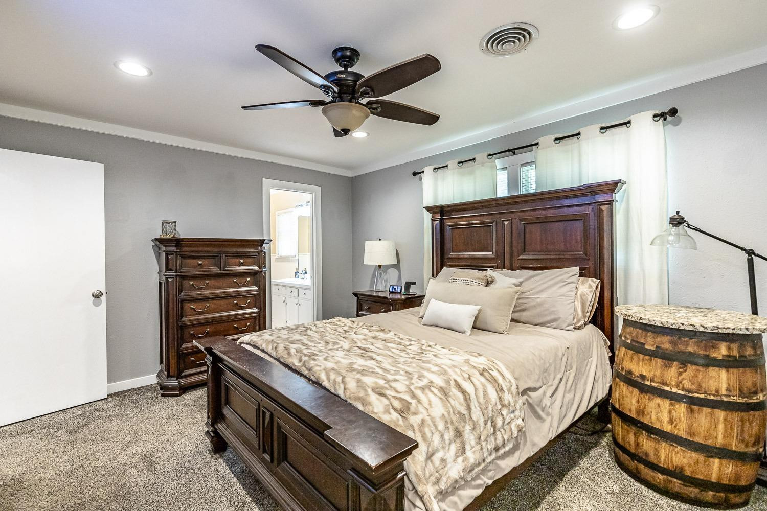 3604 48th Street Lubbock, TX 79413 - Photo 23 of 50 a bedroom with a bed a dresser and a ceiling fan