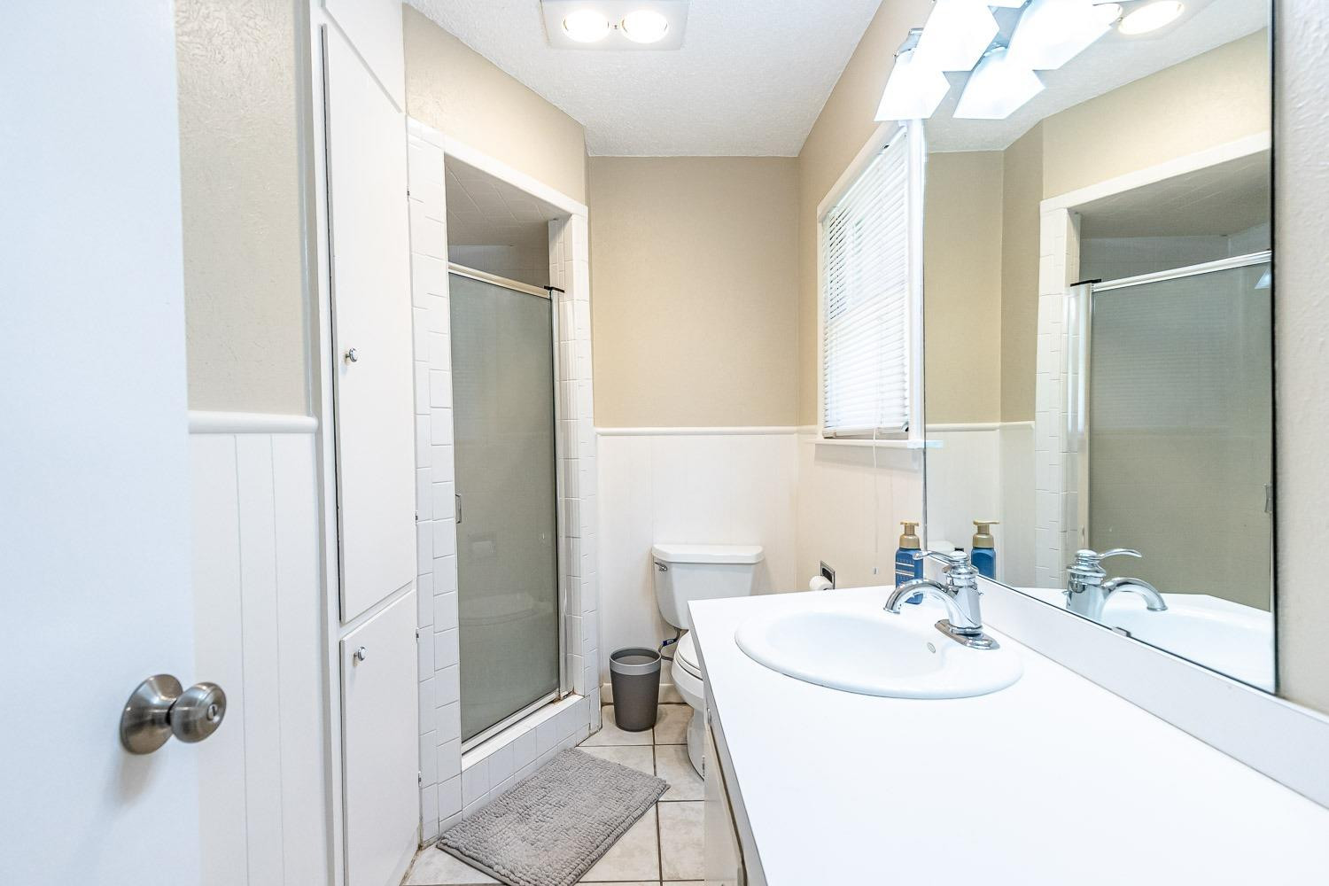 3604 48th Street Lubbock, TX 79413 - Photo 24 of 50 a bathroom with a sink and a mirror