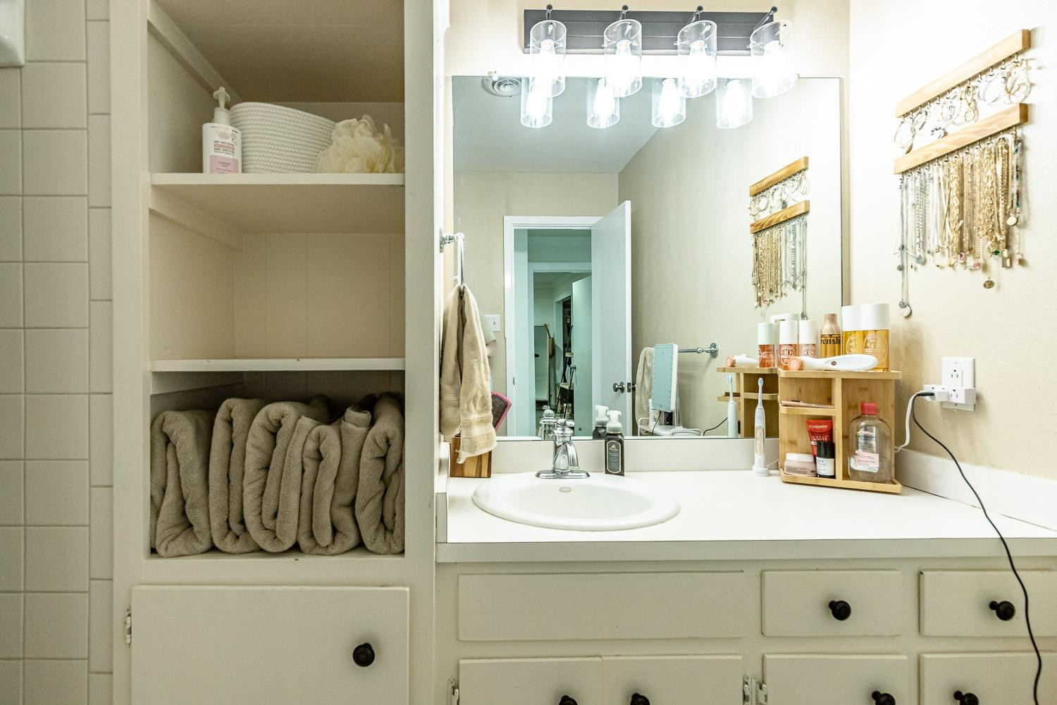 3604 48th Street Lubbock, TX 79413 - Photo 30 of 50 a bathroom with a sink and a mirror