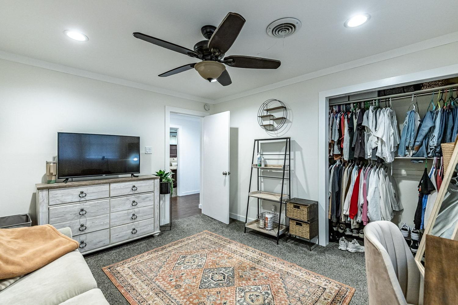 3604 48th Street Lubbock, TX 79413 - Photo 32 of 50 a living room with furniture and a flat screen tv