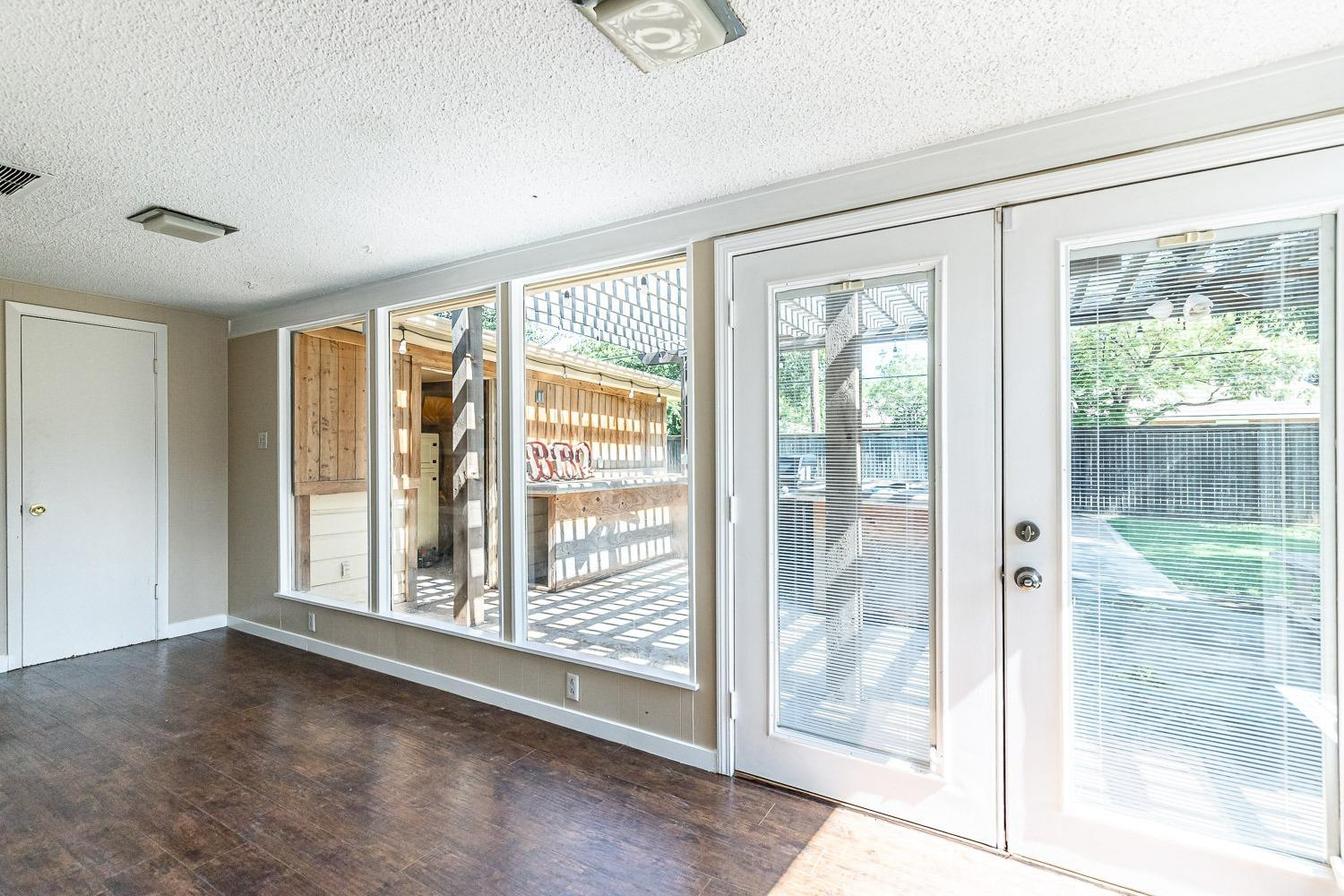 3604 48th Street Lubbock, TX 79413 - Photo 33 of 50 a view of an empty room with wooden floor and a window