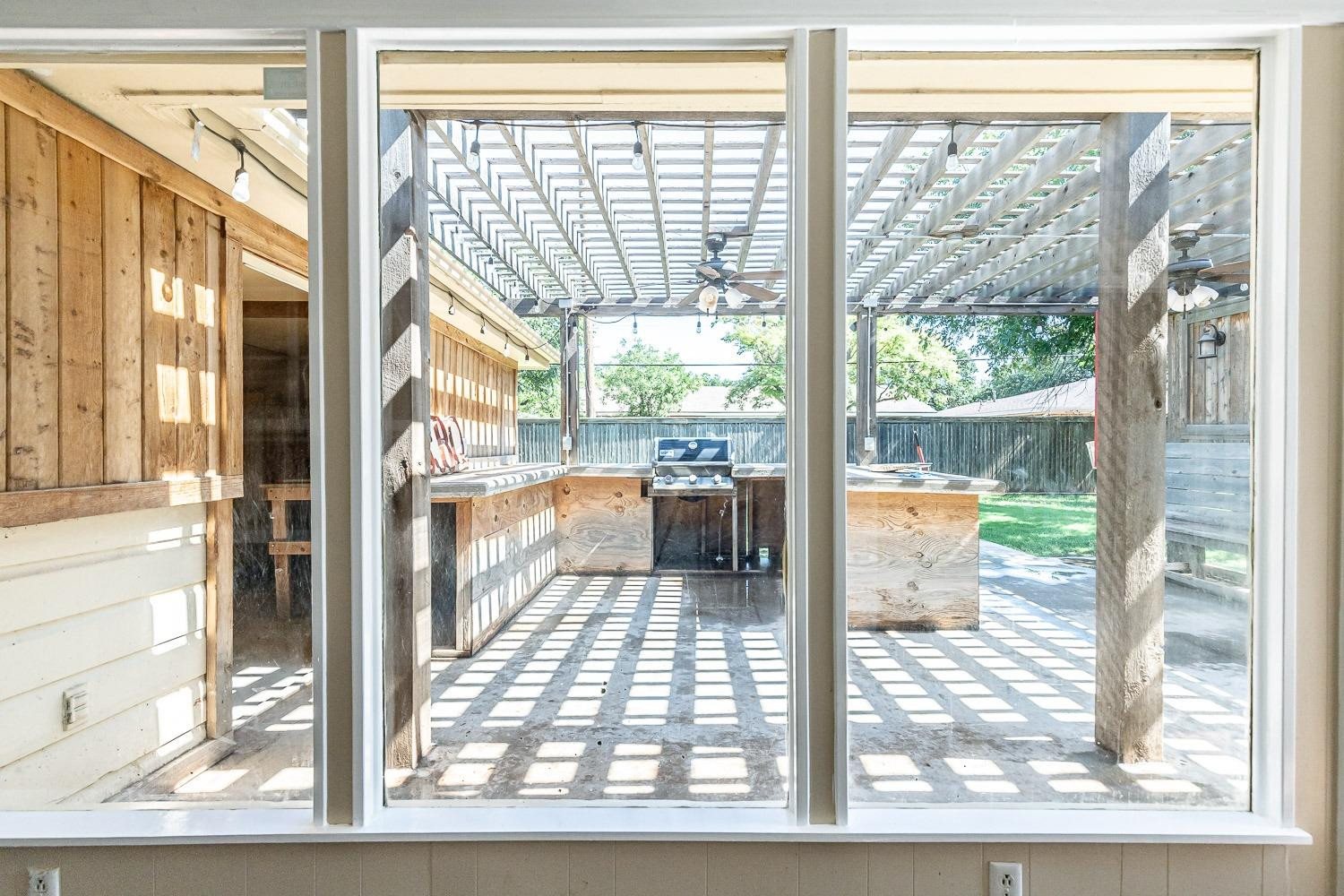 3604 48th Street Lubbock, TX 79413 - Photo 34 of 50 a view of a living room and a floor to ceiling window