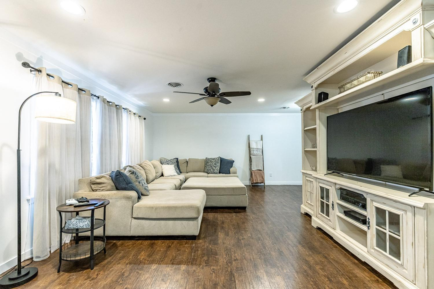 3604 48th Street Lubbock, TX 79413 - Photo 4 of 50 a living room with furniture and a flat screen tv