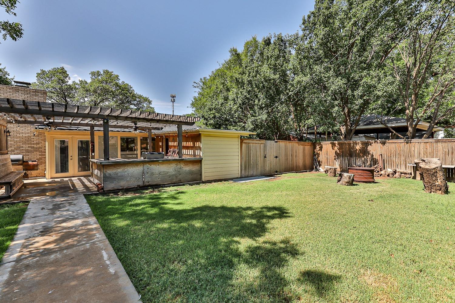 3604 48th Street Lubbock, TX 79413 - Photo 44 of 50 a view of a backyard with table and chairs and a slide