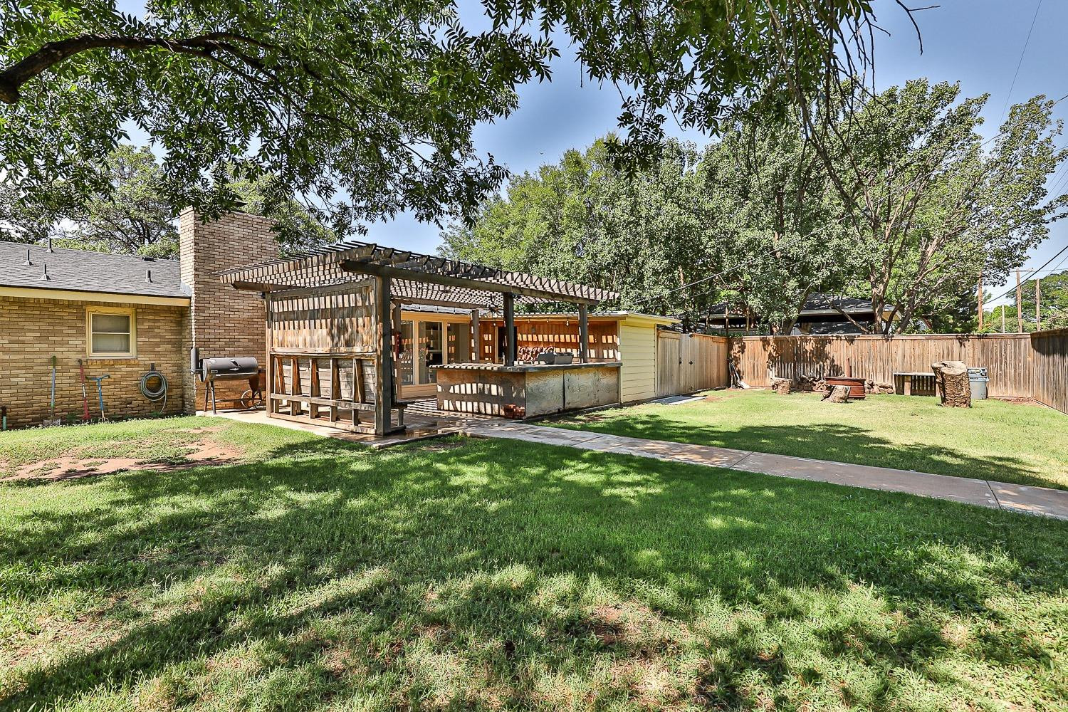 3604 48th Street Lubbock, TX 79413 - Photo 46 of 50 a view of a house with backyard and a tree