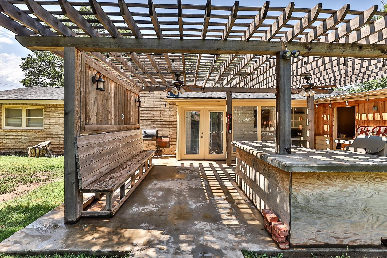 3604 48th Street Lubbock, TX 79413 - Photo 48 of 50 a view of a porch with a table and chairs