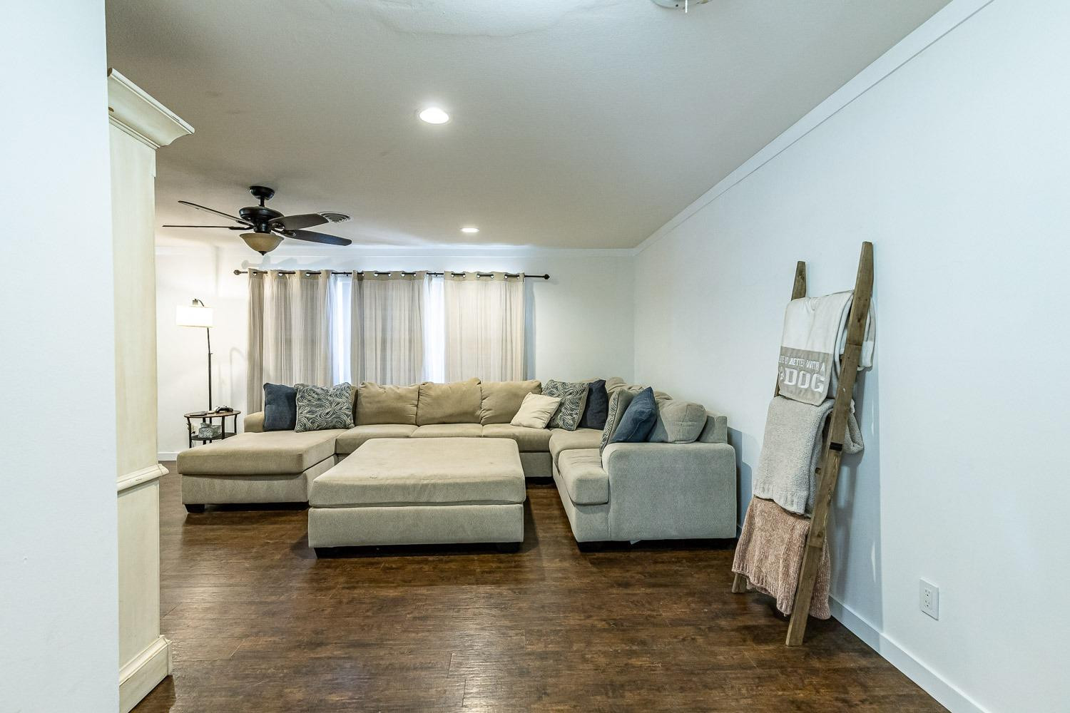 3604 48th Street Lubbock, TX 79413 - Photo 7 of 50 a living room with furniture and a chandelier