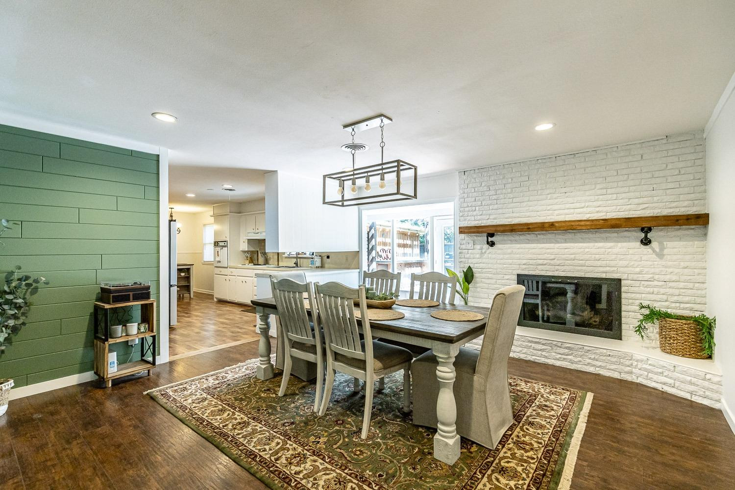 3604 48th Street Lubbock, TX 79413 - Photo 9 of 50 a dining room with furniture a rug and a fireplace