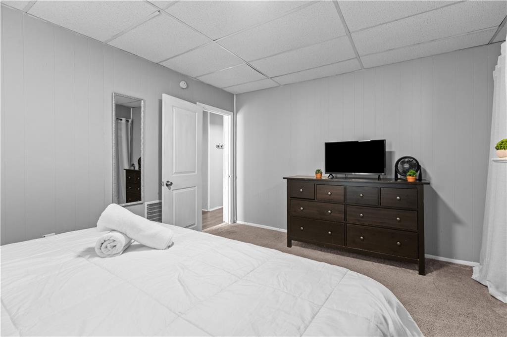 17 Lelia Street Pittsburgh, PA 15211 - Photo 11 of 26 a bedroom with a bed and a flat screen tv