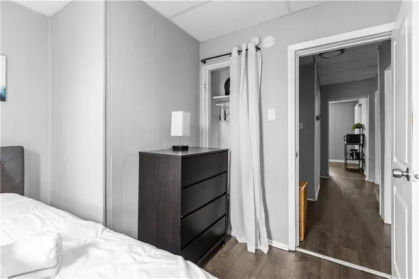 a bedroom with a bed and a mirror