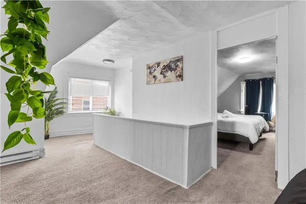 a room with a bed and a potted plant