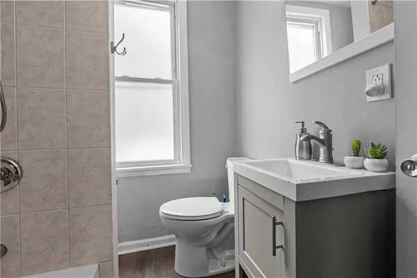 a bathroom with a sink a toilet and mirror