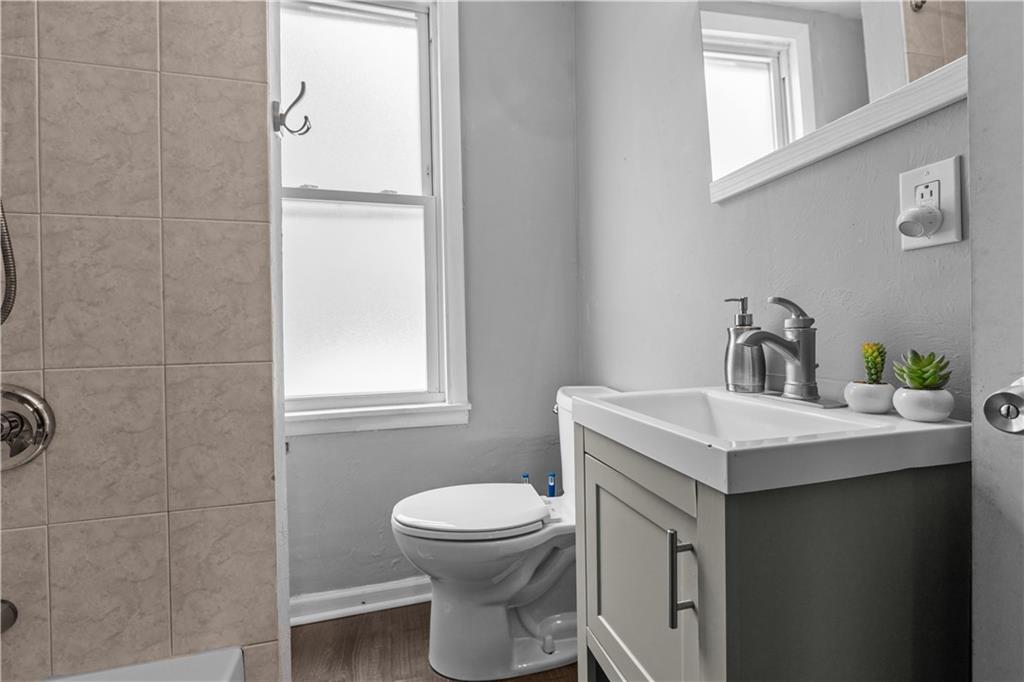 17 Lelia Street Pittsburgh, PA 15211 - Photo 15 of 26 a bathroom with a sink a toilet and mirror