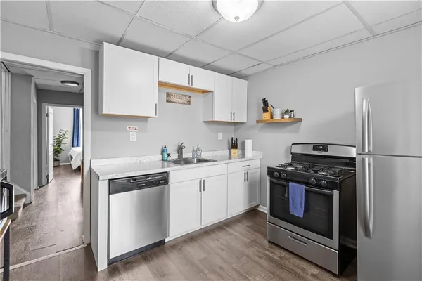 a kitchen with stainless steel appliances granite countertop a stove and a refrigerator