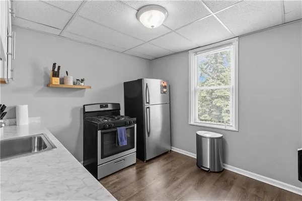 a kitchen with furniture a refrigerator and a sink