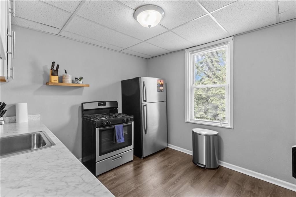 17 Lelia Street Pittsburgh, PA 15211 - Photo 18 of 26 a kitchen with furniture a refrigerator and a sink