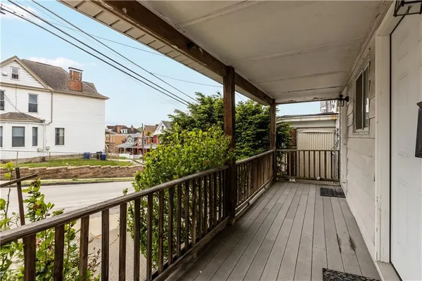 a view of balcony with wooden floor