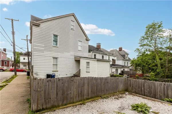 a backyard of a house with wooden fence