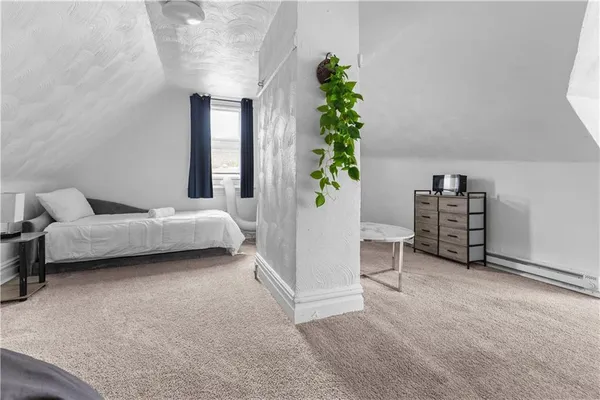 a living room with furniture and potted plant