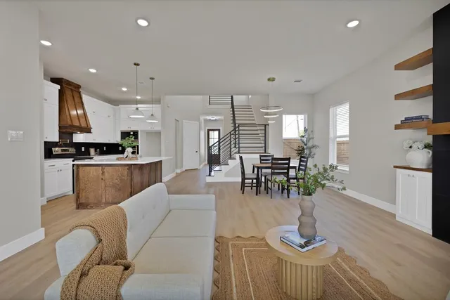 a living room with furniture and kitchen view