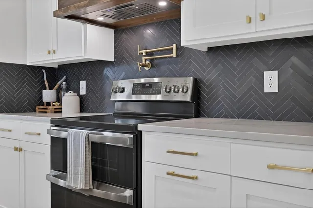 a stove top oven sitting inside of a kitchen
