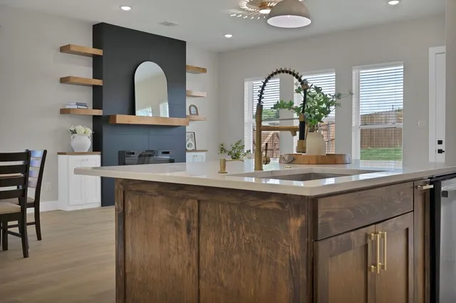 a kitchen with stainless steel appliances granite countertop a sink and a wooden cabinets