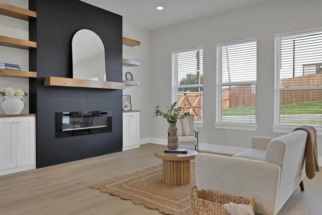 a living room with furniture and a potted plant