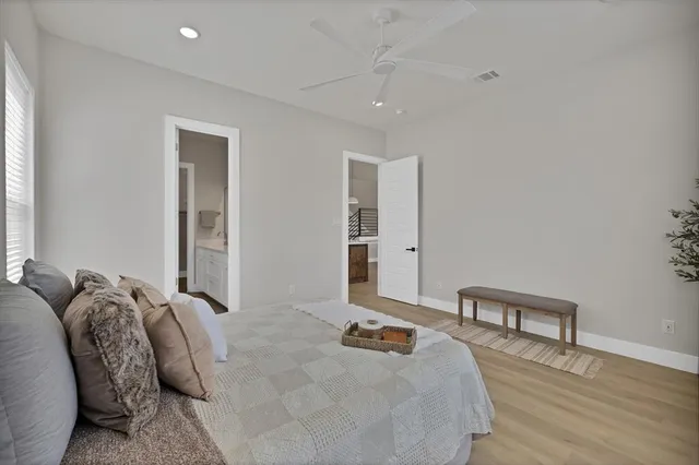 a bedroom with bed and a wooden floor