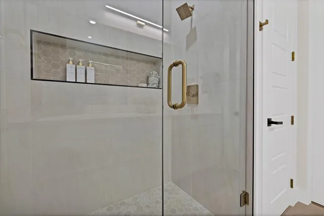 a bathroom with a glass shower door