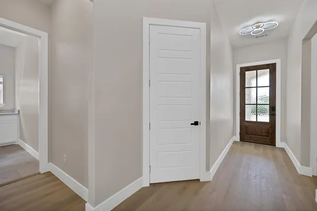 an empty room with windows and closet