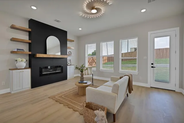 a living room with furniture and a fireplace