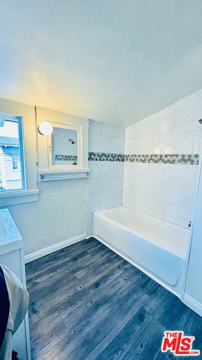 219 East 10th Street Long Beach, CA 90813 - Photo 12 of 26 a bathroom with a bathtub and a sink
