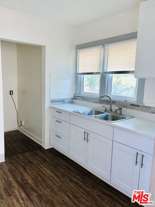 219 East 10th Street Long Beach, CA 90813 - Photo 20 of 26 a kitchen with granite countertop white cabinets and a window