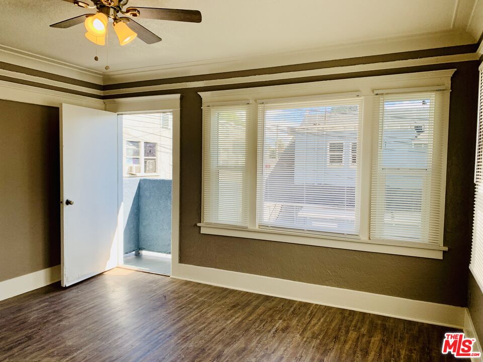 219 East 10th Street Long Beach, CA 90813 - Photo 23 of 26 a view of an empty room with a window and wooden floor