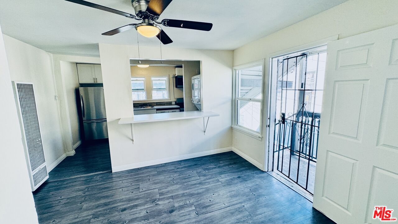 219 East 10th Street Long Beach, CA 90813 - Photo 6 of 26 a view of an entryway with wooden floor and a ceiling fan